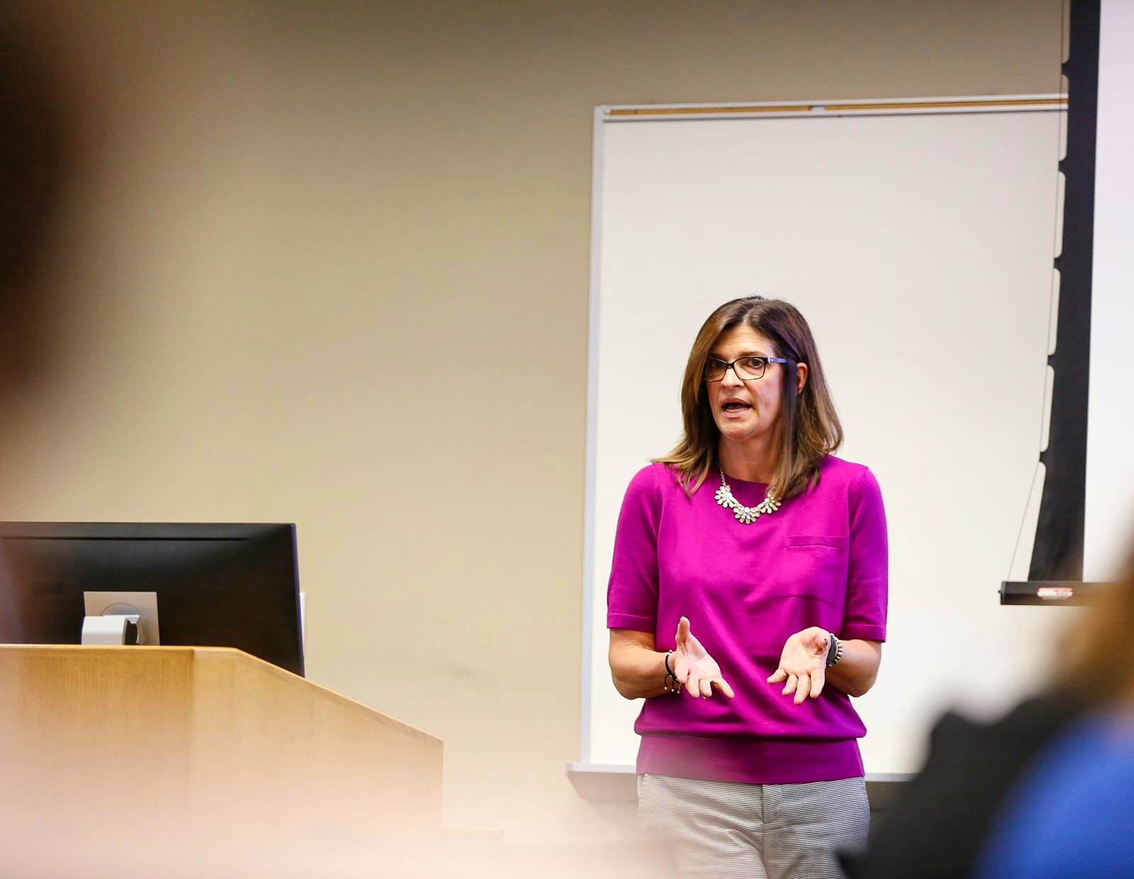 A CNL-DNP student delivering a presentation to an audience.