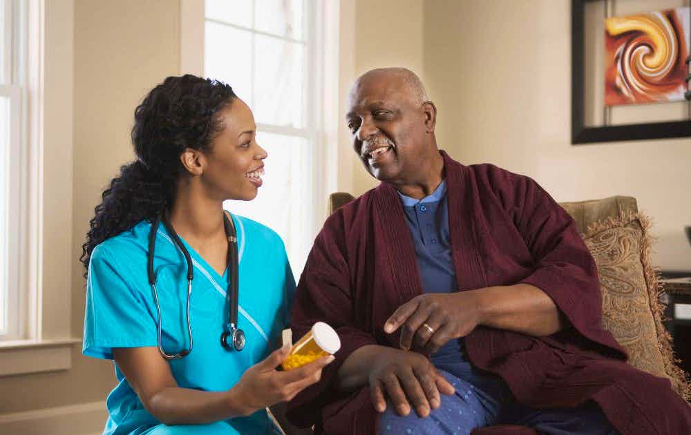 Nurse and an older adult patient talk about a medication.